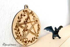 Witch ornament for laser cutting machines. It features a hand drawn pentacle with flowers.