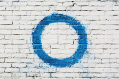 Blue Circle with Brick Wall Background Wallpaper Product Image 1