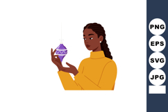 Woman holding purple Christmas ornament in yellow sweater ve Product Image 1
