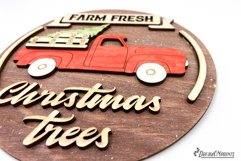 Red Christmas truck round sign with the saying "Farm fresh Christmas trees".