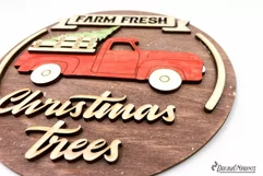 Red Christmas truck round sign with the saying "Farm fresh Christmas trees".