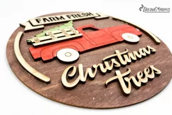Red Christmas truck round sign with the saying "Farm fresh Christmas trees".