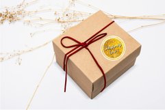 round golden Christmas sticker with a phrase saying Christmas time on a brown gift box