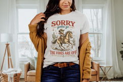 Sarcastic western themed shirt graphic featuring a cartoon cowboy cat on horseback with distressed western typography and desert cactus elements for a humorous cowgirl style design.