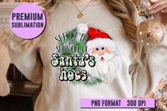Girl holding Christmas ornament wearing white sweatshirt with Christmas design