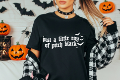This design features the quote “just a little ray of pitch black” in black gothic lettering with bat accents.