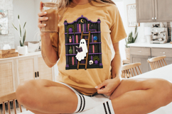 Halloween sublimation PNG with a reading ghost surrounded by books, moon decor, crystal ball, candles, plants, and witchy bookshelf details.