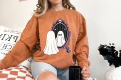 Halloween sublimation design with a charming ghost standing before a decorative skull-topped mirror, creating a whimsical spooky atmosphere.