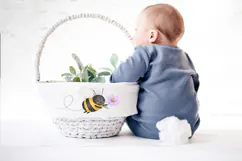 Cute hand painted bee clipart with fuzzy watercolor texture, transparent background, featuring a smiling bee flying while holding a small purple flower.