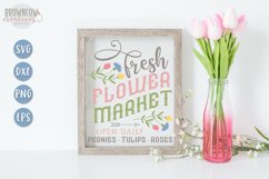 Spring Flower Market sign with hand-drawn flowers shown in a white frame with pink tulips
