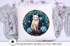 round stained glass sign with a white cat and blue flowers shown on a pillow