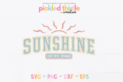 “Sunshine On My Mind” design with bold varsity lettering, soft teal and coral tones, and simple sun rays above, slightly distressed texture on a white background