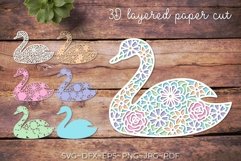 Swan svg layered template being used as a 3d layered bird paper cut