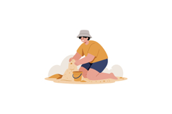 Child wearing hat and orange shirt building sandcastle on be Product Image 1