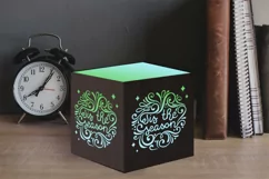 tis the season papercut lantern on table with clock
