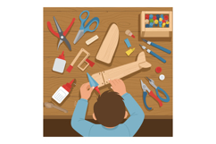 Child making wooden airplane craft with tools and paint on w Product Image 1