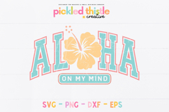 Island vibe graphic featuring arched ALOHA lettering with a flower replacing the center space and a small “on my mind” banner underneath in coordinating colors