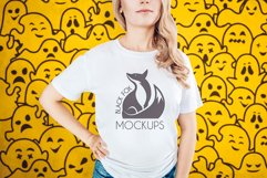 Halloween White t-shirt model mockup on orange ghosts BG Product Image 1