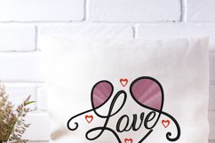 Love embroidery design shown on small cushion 