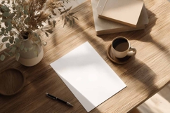 Blank White Paper on Wooden Table Product Image 1
