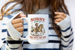 Western humor graphic with a cowboy cat riding through a desert scene surrounded by cactus and stars, paired with funny phrase typography perfect for western boutique shirt designs.