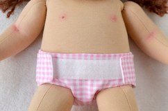 Diaper for 14-15 inch (36-38 cm) Waldorf baby doll, including printable PDF sewing pattern and step-by-step tutorial for creating handmade doll clothes and accessories, perfect for DIY projects.