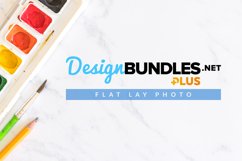 flat lay image of watercolor paints, brush and pencil