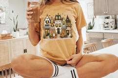 Whimsical haunted village PNG with a bakery, book shop, coffee and treats shop, produce market, pumpkins, black rooftops, and cozy spooky fall colors.
