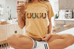 Decorative horseshoes with hand painted flowers in turquoise, rust, and cream tones arranged across a clean background. Western boho aesthetic digital artwork for sublimation printing and DIY craft projects.