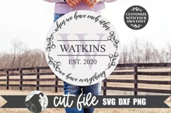 monogram Wreath Family Last Name Farmhouse SVG shown on a round wood sign