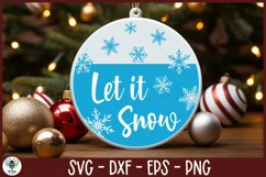 Let it snow with snowflakes SVG design being shown on a round Christmas ornament