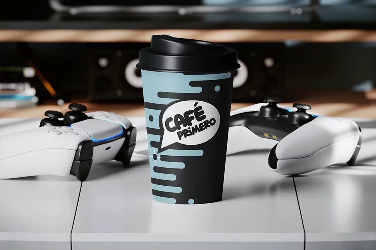 Paper Coffee Cup on the Table Near the Gamepads Mockup