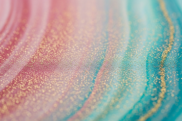 Swirling pink, blue, and gold glitter patterns