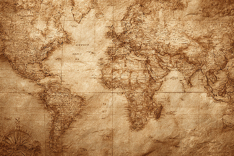 World map on parchment paper with a classic compass