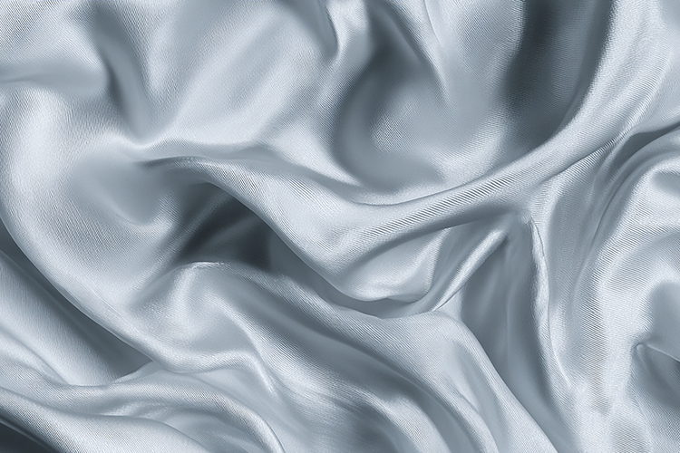 Light blue satin fabric with gentle folds and creases