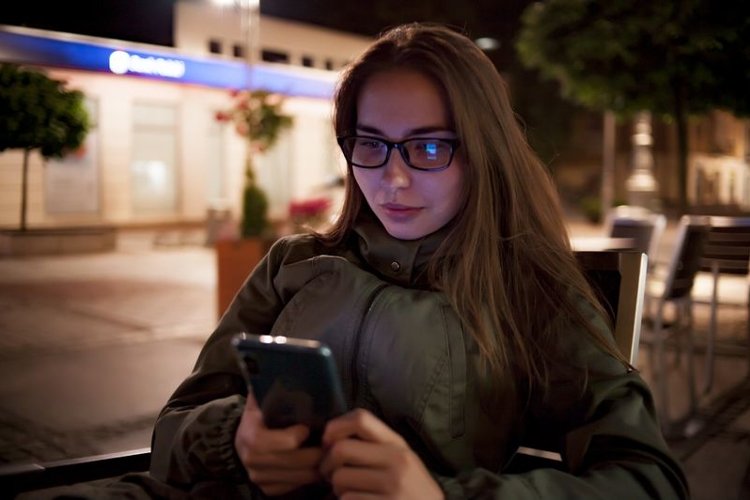 Young caucasian women in glass sitting in street cafe