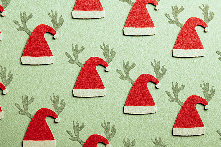 A festive pattern of Santa hats and reindeer antlers