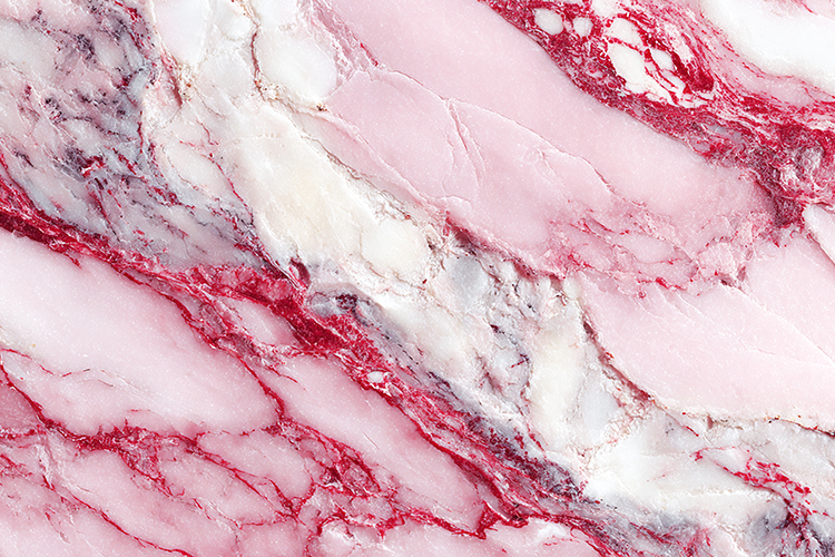 A pink marble surface with red veins