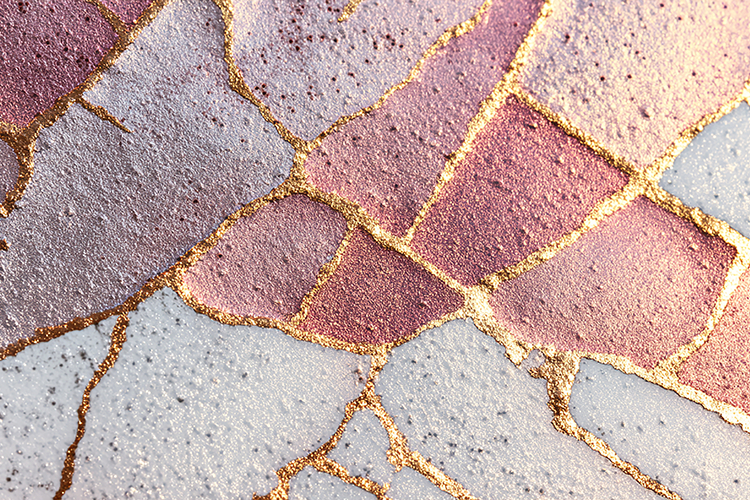 Cracked and weathered stone surface with gold accents