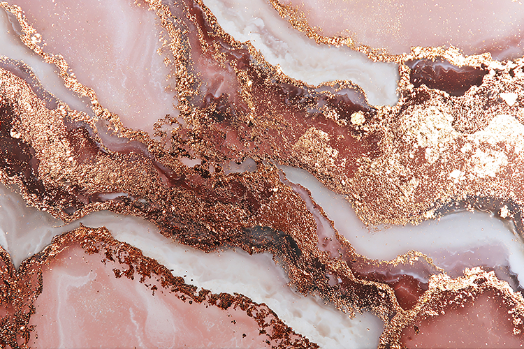 A pink marble surface with gold accents