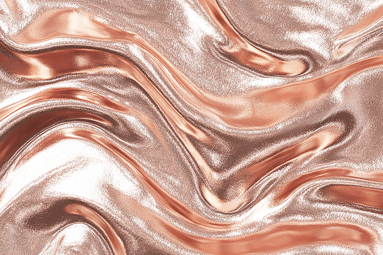 A shiny, rose-gold metallic surface with wavy
