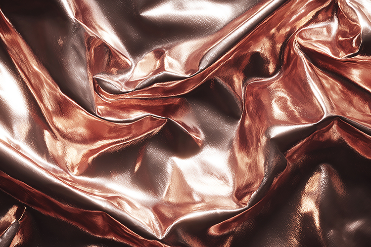 Crinkled metallic fabric with a shiny rose gold surface