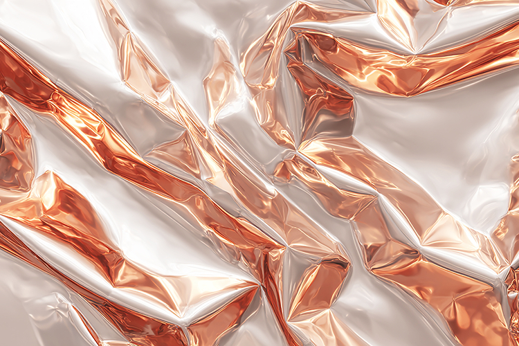 Crumpled metallic foil with shiny copper and silver surfaces