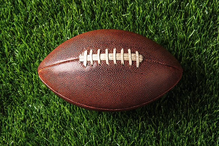 Close-Up American Football on Grass Field Sports Background