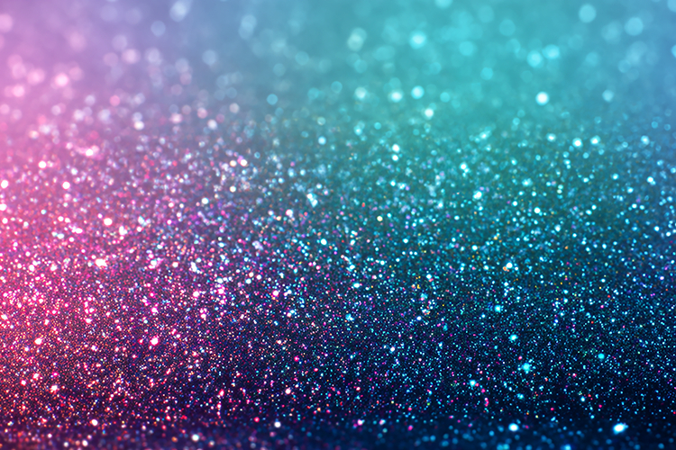 Sparkling particles in shades of pink, blue, and purple hues