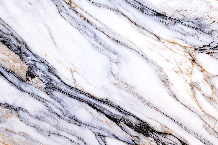 A white marble surface with black and gold veins