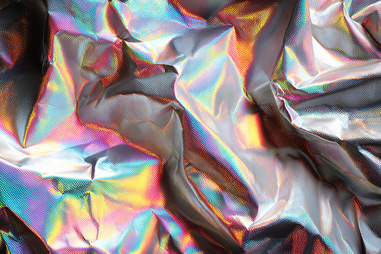 A vibrant and colorful crumpled holographic foil background