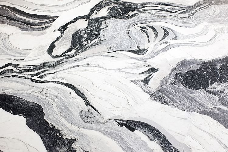 A close-up view of a marble surface with swirling black
