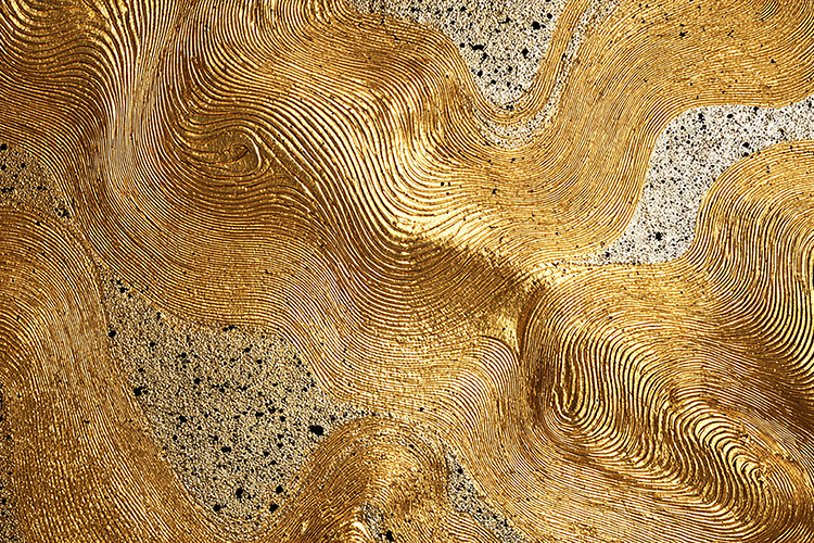 A textured golden surface with intricate patterns and lines