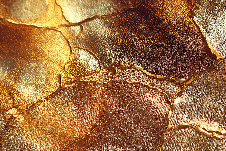 Cracked & weathered gold surface with a textured appearance